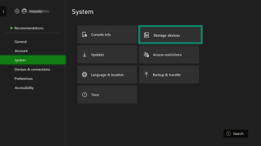 Xbox Settings menu with System selected and the Storage devices option highlighted.